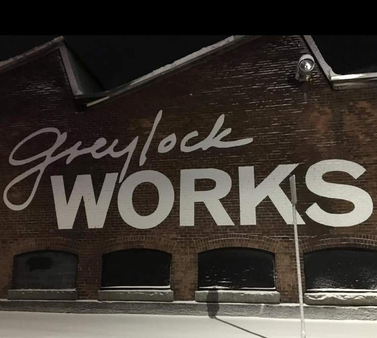 The Greylock WORKS sign painted on the mill wall
