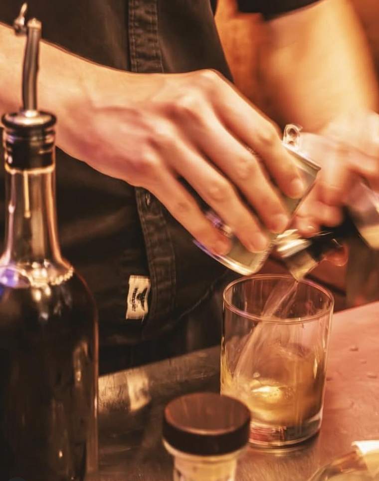 A cocktail being built behind the bar